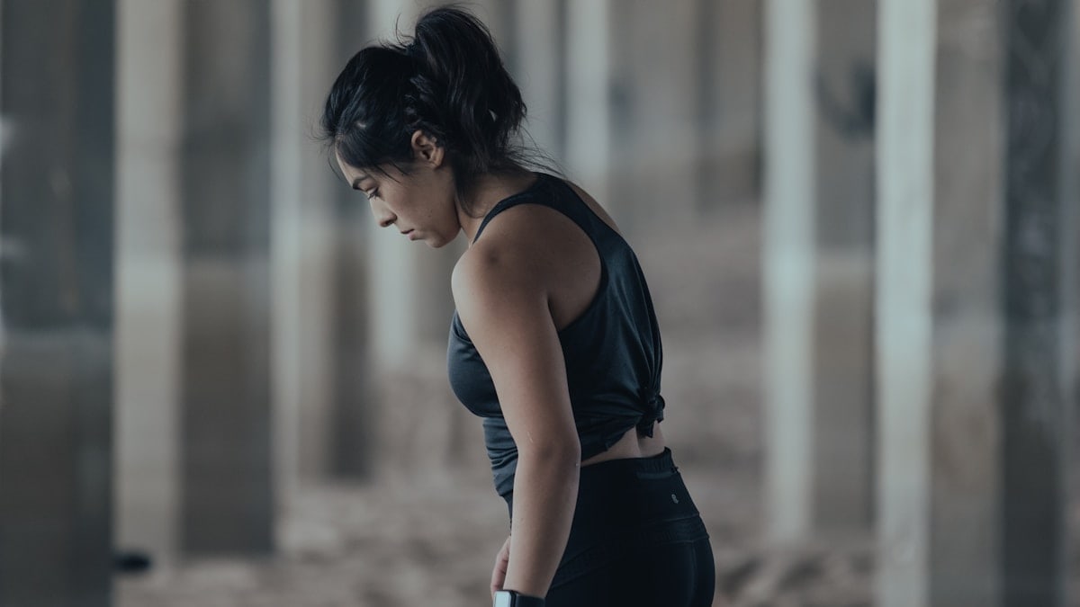 woman in blue tank top and black leggings